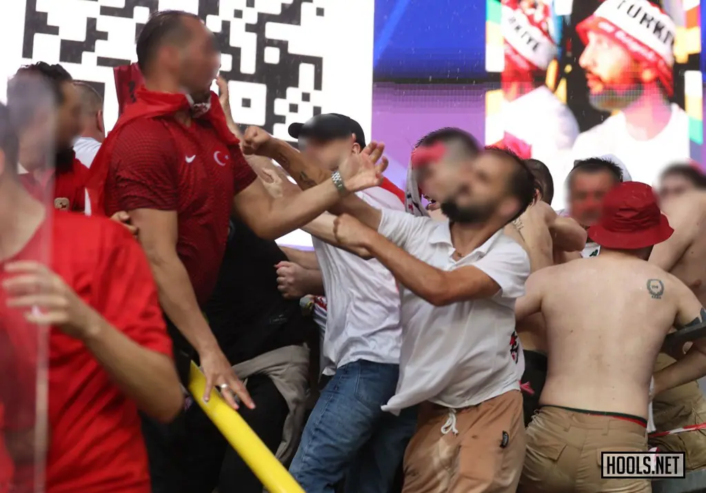 A Georgia fan launches a punche towards a Turkey fan