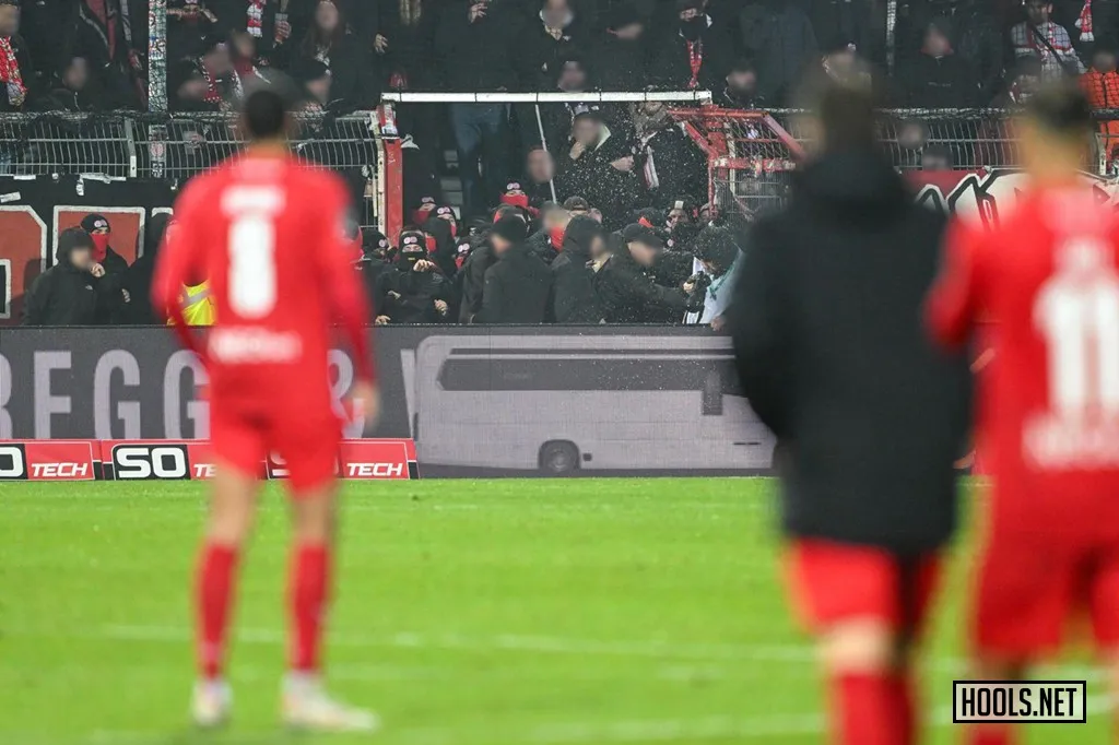 RW Essen fans break out of their end and into the area between the stands and the pitch.